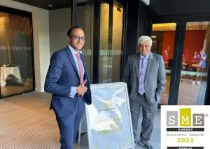 Our founder and managing director next to a SME Surrey Awards sign.