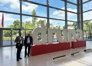 Our founder and managing director next to a DRUPA 2024 sign at the event
